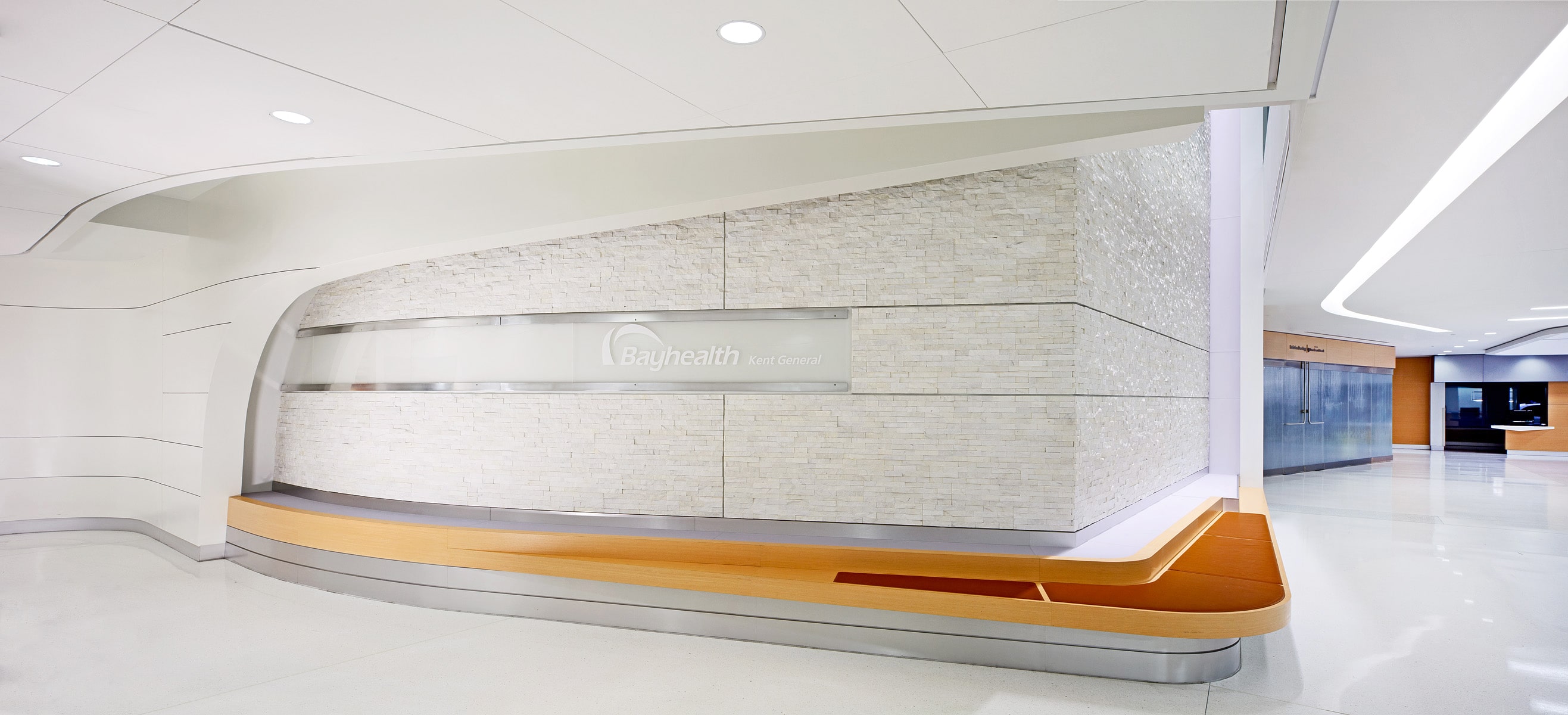 Norstone White Rock Panels on large feature wall at hospital with curved walls and benches